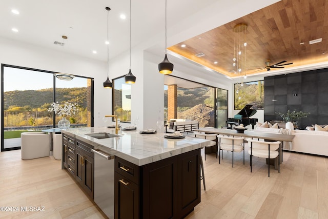 kitchen featuring light stone countertops, dishwasher, ceiling fan, wooden ceiling, and pendant lighting