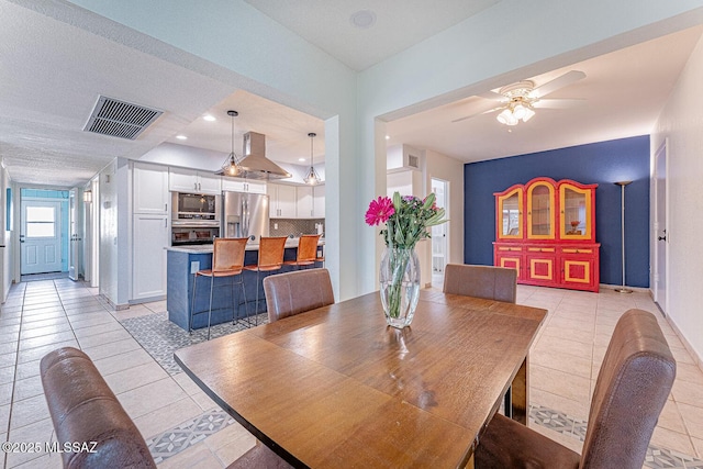 tiled dining area featuring ceiling fan