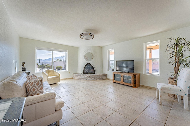 tiled living room with a brick fireplace and a textured ceiling