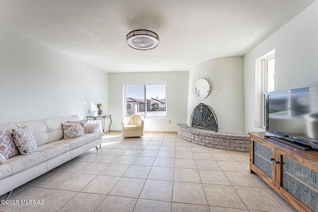 tiled living room with a brick fireplace and a textured ceiling