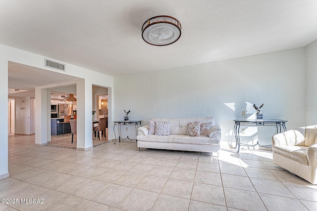 unfurnished living room with light tile patterned floors