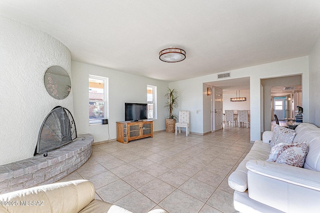 living room featuring light tile patterned floors and a fireplace