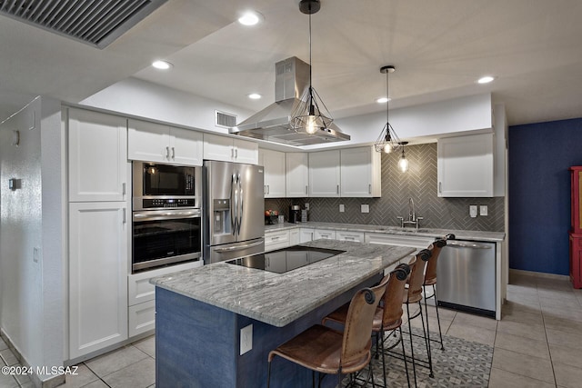 kitchen with decorative light fixtures, a center island, black appliances, island exhaust hood, and white cabinets