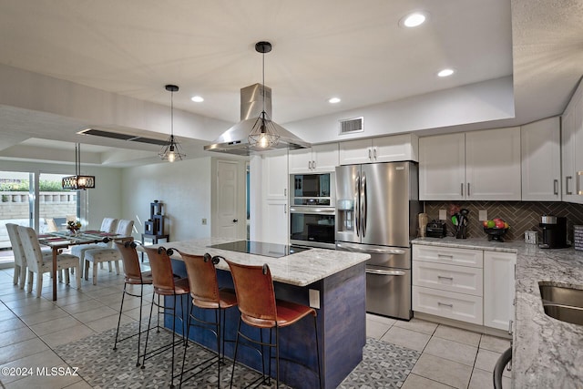 kitchen featuring pendant lighting, white cabinets, and black appliances