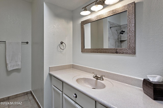 bathroom with vanity, tile patterned flooring, and a shower