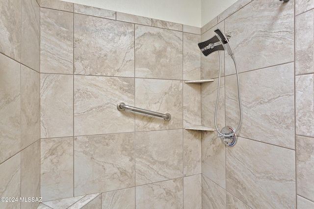 interior details with a tile shower