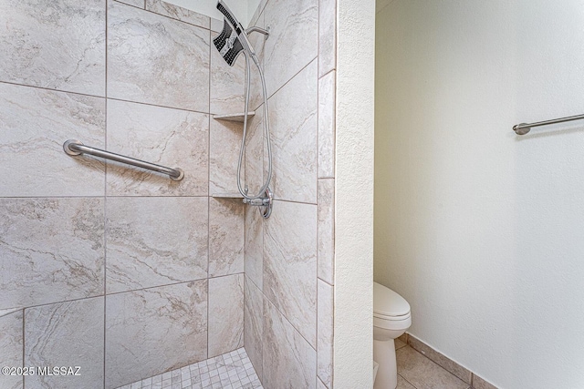 bathroom with tiled shower and toilet