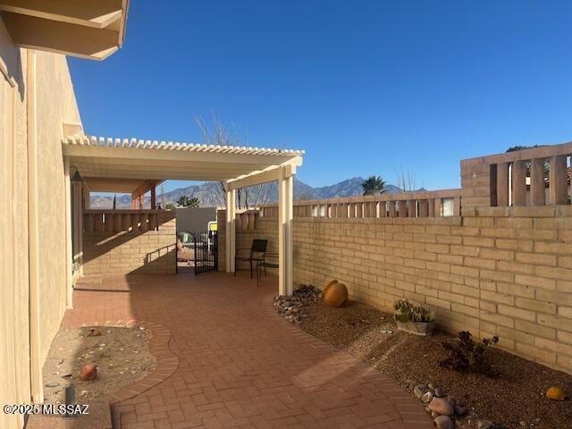 view of patio with a pergola and a mountain view