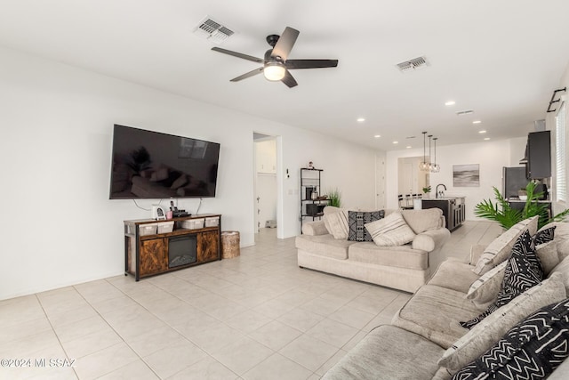 tiled living room featuring ceiling fan