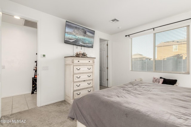 bedroom featuring light colored carpet