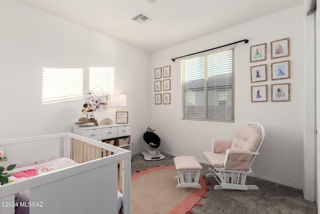 bedroom with carpet floors and a nursery area