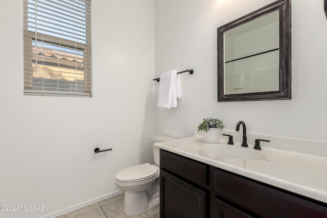 bathroom featuring tile patterned flooring, vanity, and toilet