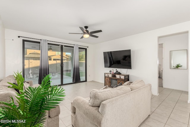 living room with ceiling fan and light tile patterned flooring