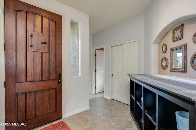 foyer featuring plenty of natural light and light tile patterned flooring