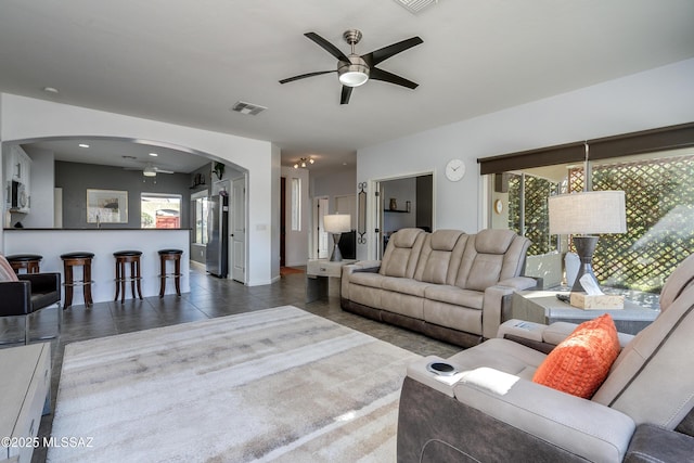 tiled living room featuring ceiling fan