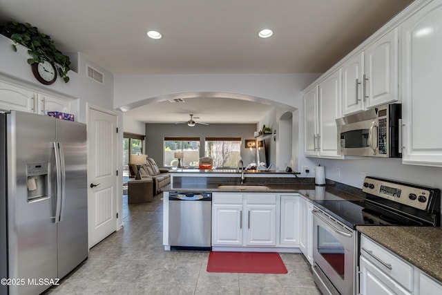 kitchen with sink, white cabinetry, kitchen peninsula, ceiling fan, and stainless steel appliances