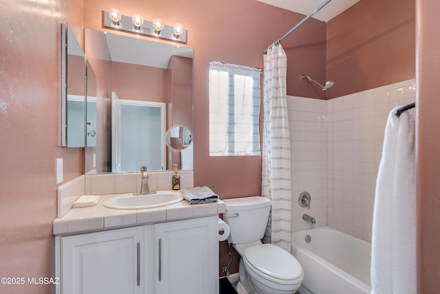 full bathroom with vanity, shower / tub combo, and toilet