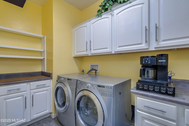 laundry room with cabinets, separate washer and dryer, and dark tile patterned flooring