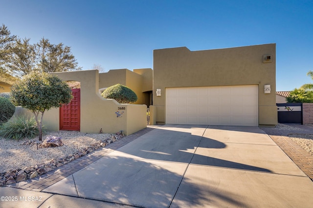 pueblo revival-style home with a garage