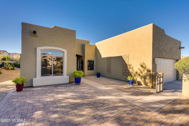 rear view of property with a garage