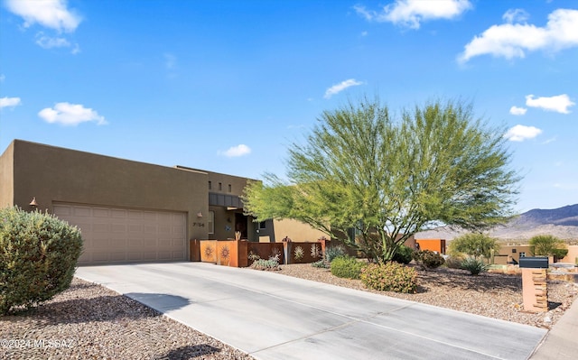 pueblo-style house featuring a mountain view and a garage