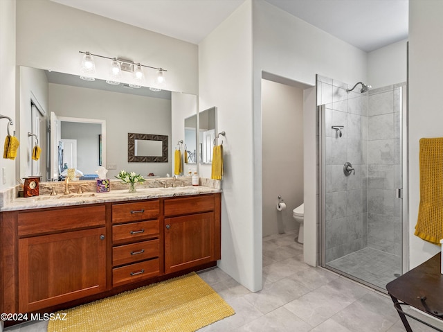 bathroom with tile patterned flooring, vanity, toilet, and a shower with shower door