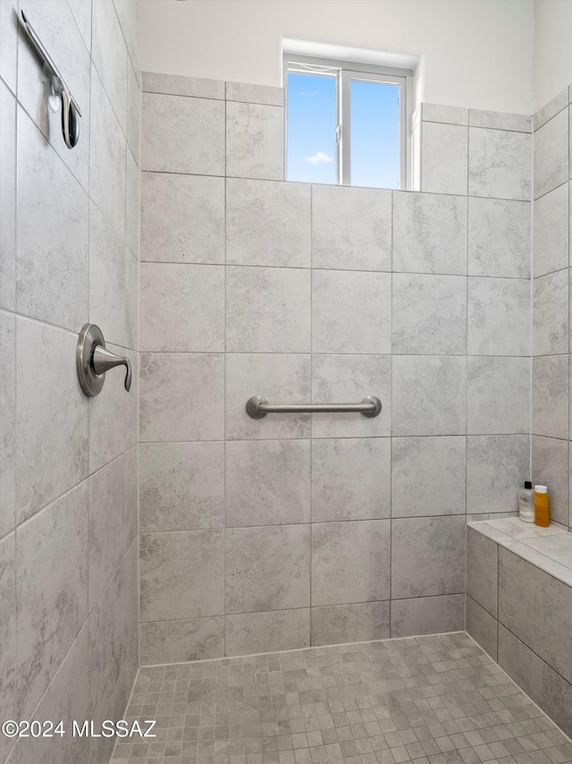 bathroom with a tile shower