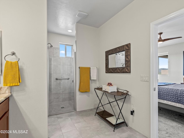 bathroom featuring vanity, ceiling fan, and an enclosed shower