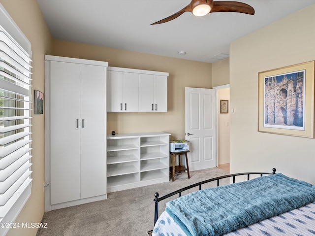 bedroom featuring ceiling fan and light colored carpet