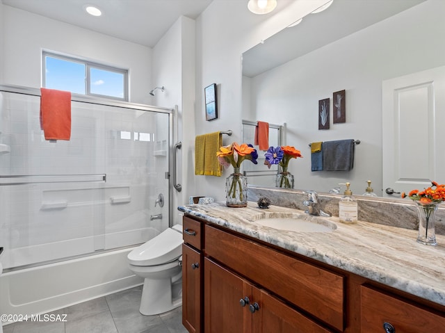 full bathroom with tile patterned flooring, vanity, toilet, and enclosed tub / shower combo