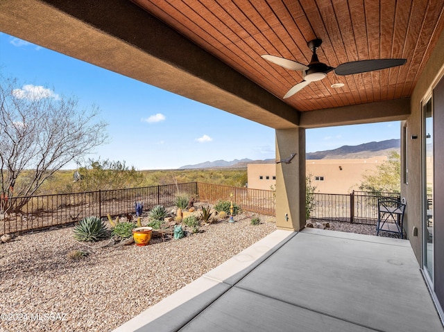 view of patio featuring a mountain view and ceiling fan