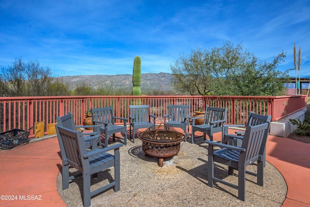 view of patio / terrace with a mountain view and an outdoor fire pit