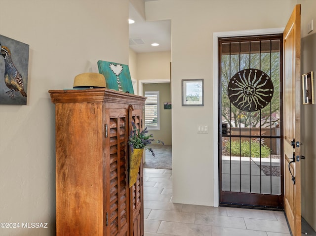 foyer featuring light tile patterned flooring