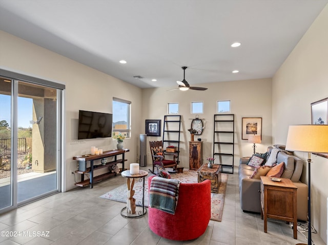 living room featuring ceiling fan and a healthy amount of sunlight