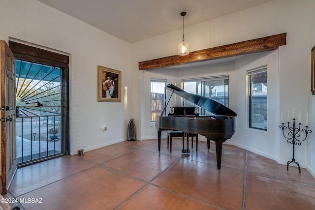 living area featuring concrete floors and baseboards