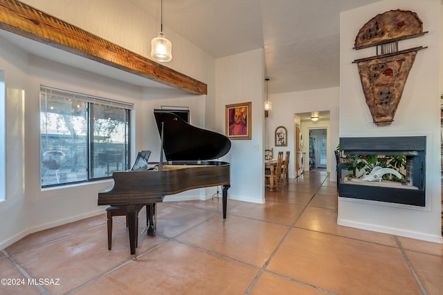 living area with concrete flooring, a multi sided fireplace, and baseboards