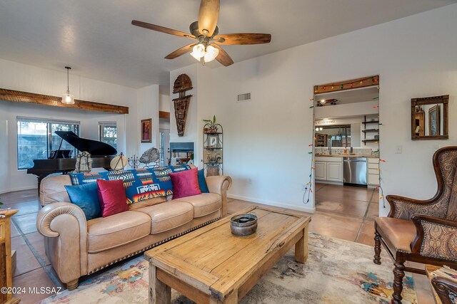 living room featuring light tile patterned flooring and ceiling fan