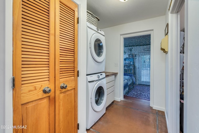 clothes washing area with stacked washer / drying machine