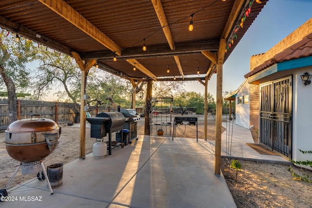 view of patio with a grill and fence