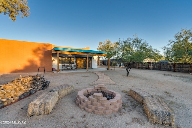 view of patio / terrace with fence and a fire pit