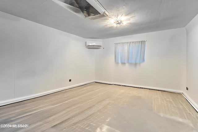 spare room featuring a wall unit AC and visible vents