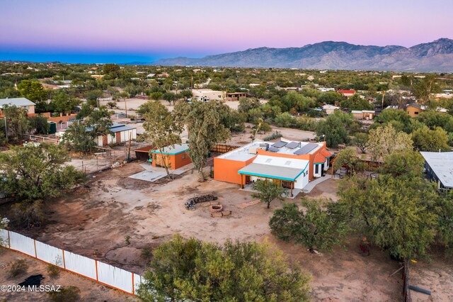 aerial view at dusk featuring a mountain view