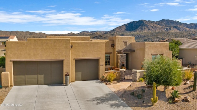 southwest-style home featuring a mountain view and a garage