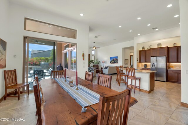 kitchen featuring light stone countertops, appliances with stainless steel finishes, backsplash, and dark brown cabinets