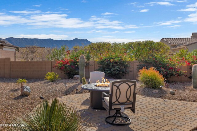 view of patio / terrace with a mountain view, area for grilling, and ceiling fan