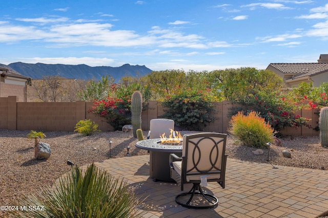 36513 S Cactus Ln, Tucson, AZ 85739 - view of patio / terrace with a mountain view, a fenced backyard, and an outdoor fire pit