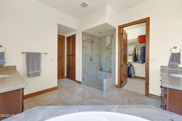 36513 S Cactus Ln, Tucson, AZ 85739 - bathroom with visible vents, vanity, a stall shower, baseboards, and a spacious closet