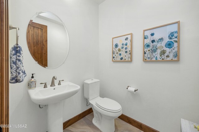 bathroom featuring tile patterned flooring, vanity, toilet, and walk in shower