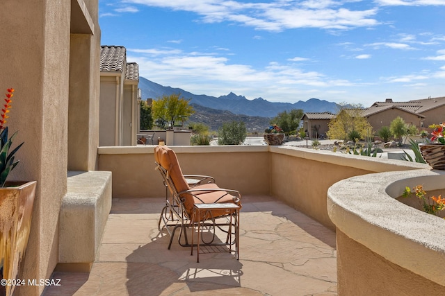 view of patio / terrace featuring a mountain view and a balcony