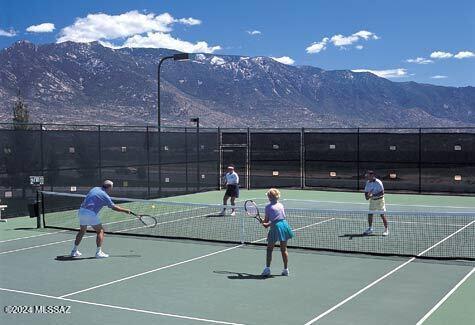 view of tennis court with a mountain view